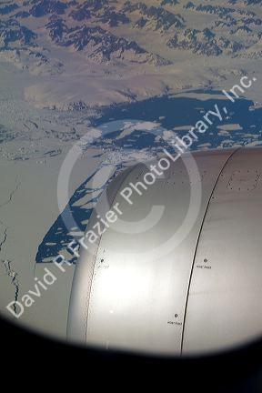 Aerial view of the glaciers and icebergs of Greenland from the window of an Airbus 330 passenger jet airliner.