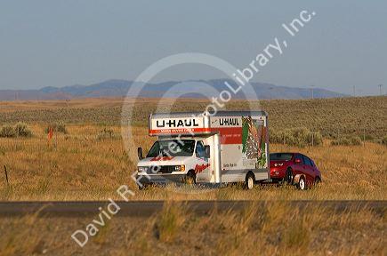 U-haul truck hauling a car on Interstate 84 near Boise, Idaho, USA.