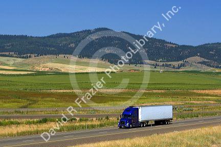 Truck transporting freight along Interstate 84 near North Powder, Oregon, USA.