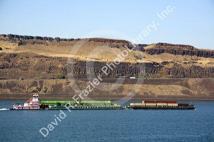 Barges being pushed up the Columbia River by a tugboat near the John Day Dam, Oregon, USA.