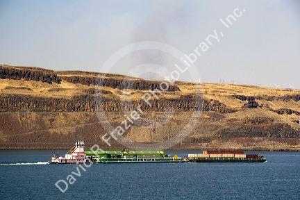 Barges being pushed up the Columbia River by a tugboat near the John Day Dam, Oregon, USA.