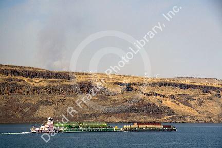 Barges being pushed up the Columbia River by a tugboat near the John Day Dam, Oregon, USA.