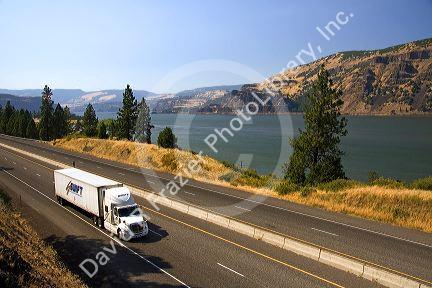 Truck transporting freight through the Columbia River Gorge near Hood River, Oregon, USA.