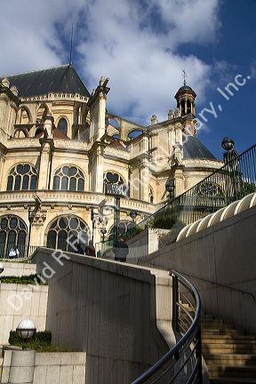 Eglise Saint-Eustache gothic architecture contrasting with the modern staircase of Les Halles in Paris, France.
