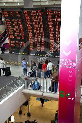 Departure board located in the Paris-Charles de Gaulle Airport, Paris, France.
