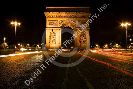 Arc de Triomphe lit at night stands in the centre of the Place Charles de Gaulle, Paris, France.