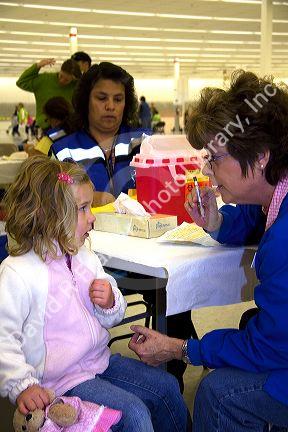 Health care professional administering the nasal spray H1N1 influenza vaccine to a child in Boise, Idaho.
