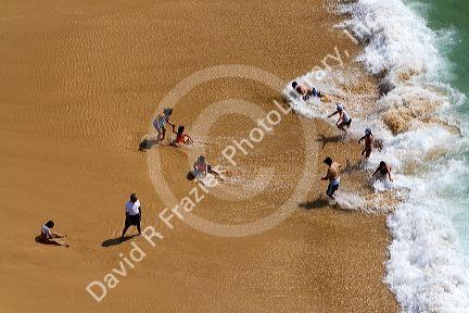 People play on the beach and in the surf in Acapulco, Guerrero, Mexico.