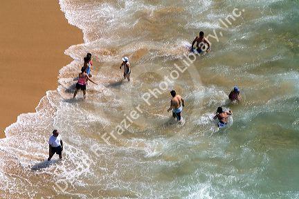 People play on the beach and in the surf in Acapulco, Guerrero, Mexico.