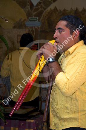 Musician playing a traditional panpipe in the city of Puebla, Puebla, Mexico.
