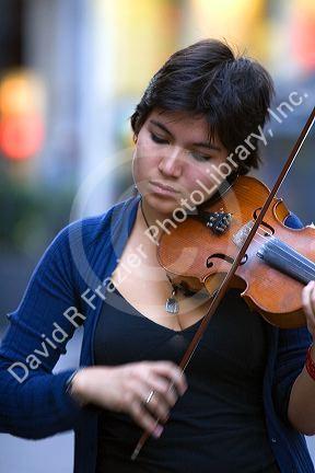 Street performer playing the violin in Mexico City, Mexico.