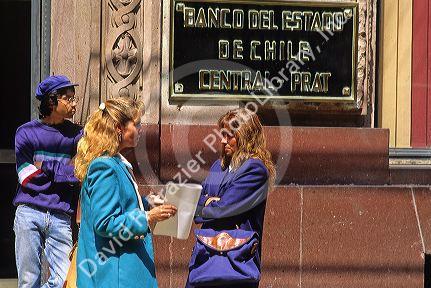 Businesswomen have a conversation on the street in Santiago, Chile.