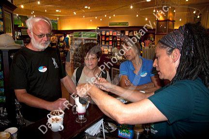 Barista making coffee drinks with tourists at the Britt coffee bar in San Rafael de Heredia, Costa Rica.