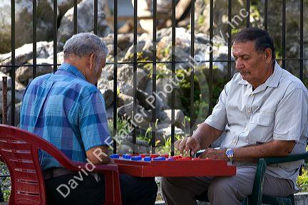 Costa Rican men playing a game of checkers on the street in Limon, Costa Rica.