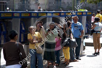 People using pay telephones in the city of San Jose, Costa Rica.