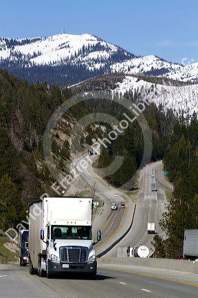 Vehicles travel on Interstate 80 near Donner Pass in the Sierra Nevada mountains, California, USA.