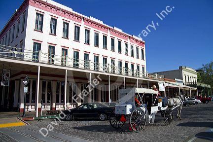 Tourists ride in a horse drawn carriage at Old Sacramento State Historic Park in Sacramento, Califorina, USA.