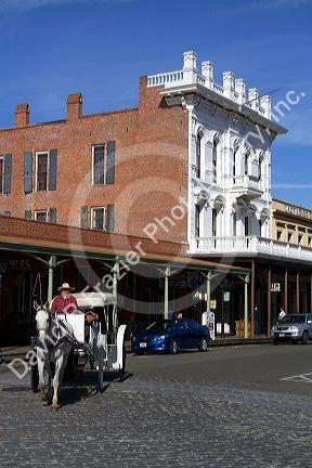 Tourists ride in a horse drawn carriage at Old Sacramento State Historic Park in Sacramento, Califorina, USA.