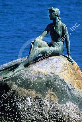 A bronze sculpture of a girl in wetsuit by Elek Imredy Stanley Park in Vancouver, Canada.