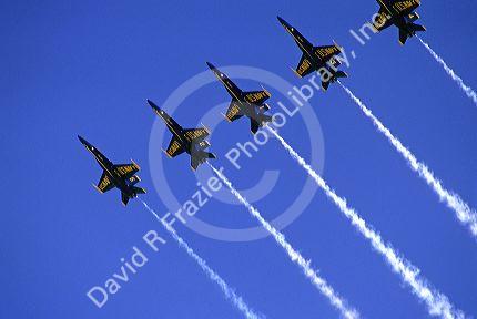 The Blue Angels F/A-18 Hornets fly in formation.