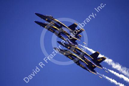 The Blue Angels F/A-18 Hornets fly in formation.