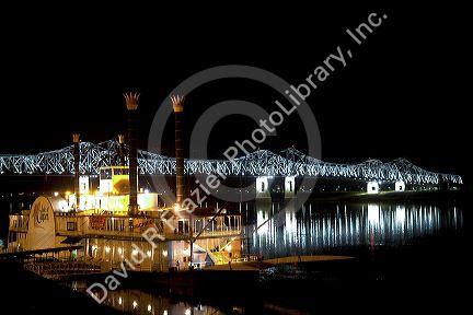 Steamboat docked at night near the Natchez-Vidalia Bridges spanning the Mississippi River between Vidalia, Louisiana and Natchez, Mississippi, USA.