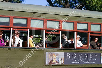 Passengers on the St. Charles Streetcar Line in the Garden District of New Orleans, Louisiana, USA.