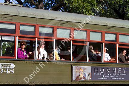 Passengers on the St. Charles Streetcar Line in the Garden District of New Orleans, Louisiana, USA.