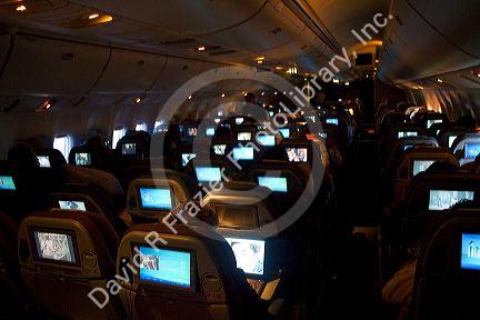 Interior of a Boeing 767 aircraft coach class cabin. 