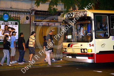 People boarding a public transportation bus in Buenos Aires, Argentina.