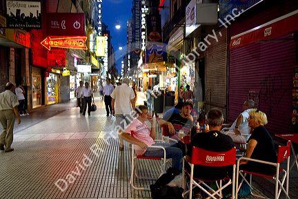 People walking on Lavalle Street at night in Buenos Aires, Argentina.