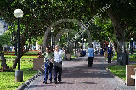 People walk in a park in the Miraflores district of Lima, Peru.
