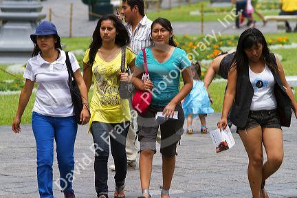 Pedestrians at the Plaza Mayor or Plaza de Armas of Lima, Peru.