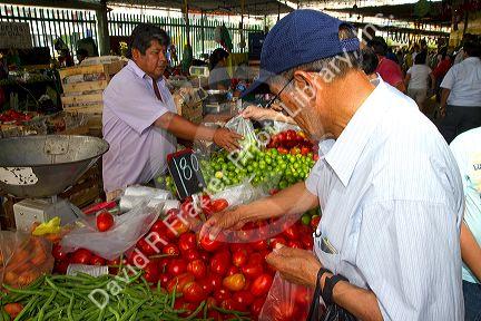 Vendor at a cooperative produce market in the Chorrillos district of Lima, Peru.