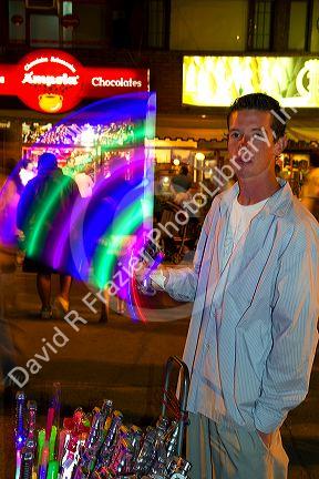 Street vendor selling glow sticks and toys at Necochea, Argentina.