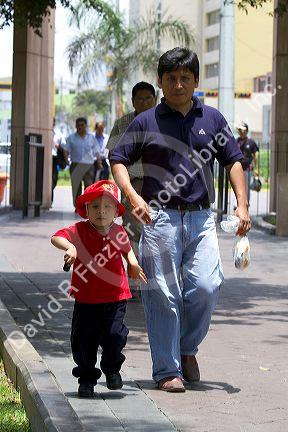 Father and son in Central Park of the Miraflores district of Lima, Peru.