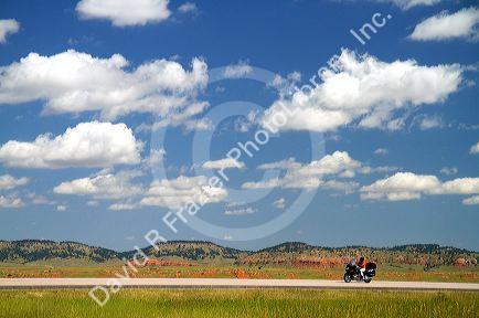 Motorcycle traveling on I-90 in northeast Wyoming near the South Dakota border, USA.
