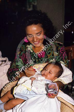 A hispanic mother feeding her baby in Mexico.