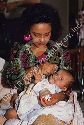 A hispanic mother feeding her baby in Mexico.