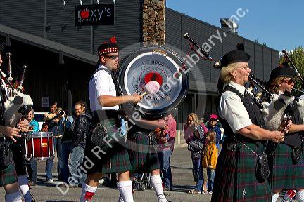 The Boise Highlanders playing bagpipes and drums in the Trailing of the Sheep Parade on Main Street in Ketchum, Idaho, USA.