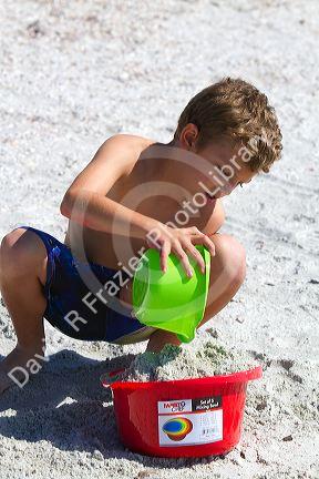 Seven year old boy playing at Madeira Beach in Pinellas County, Florida, USA.