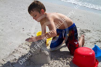 Seven year old boy playing at Madeira Beach in Pinellas County, Florida, USA.