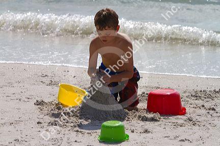 Seven year old boy playing at Madeira Beach in Pinellas County, Florida, USA.