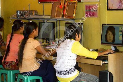 Burmese youth using computers at a photo processing store in (Rangoon) Yangon, (Burma) Myanmar.