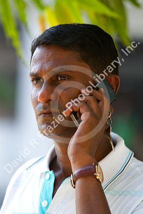 Burmese man using a cell phone in (Rangoon) Yangon, (Burma) Myanmar.