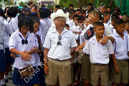 Thai school students wearing uniforms visit The Grand Palace in Bangkok, Thailand.