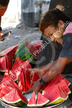 Street vendor selling sliced watermelon in (Rangoon) Yangon, (Burma) Myanmar.