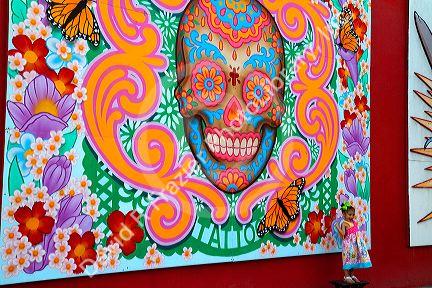 Mural on the side of a tattoo shop being used as a backdrop for a portait in Corpus Christi, Texas, USA.