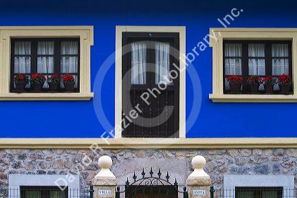 Residential housing with flowers in windows in the municipality of Cangas de Onis in Asturias, Spain.
