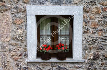 Residential housing with flowers in windows in the municipality of Cangas de Onis in Asturias, Spain.